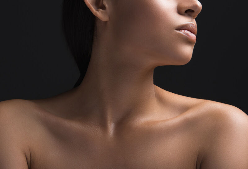 Womans neck on a gray background